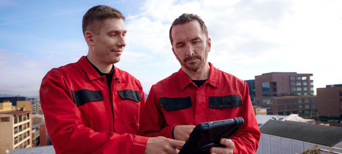 Two workers looking at a tablet device