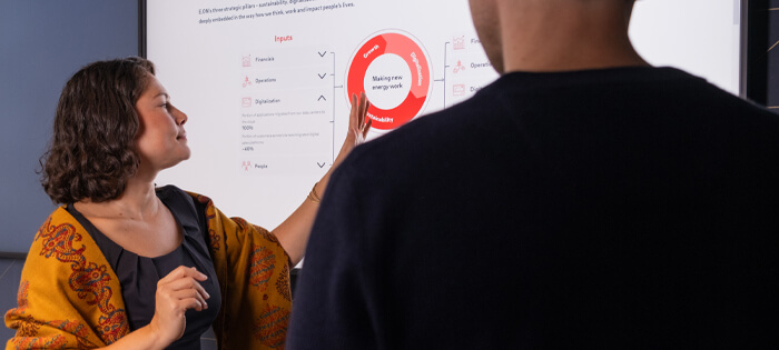 Two people looking at a red graphic on screen